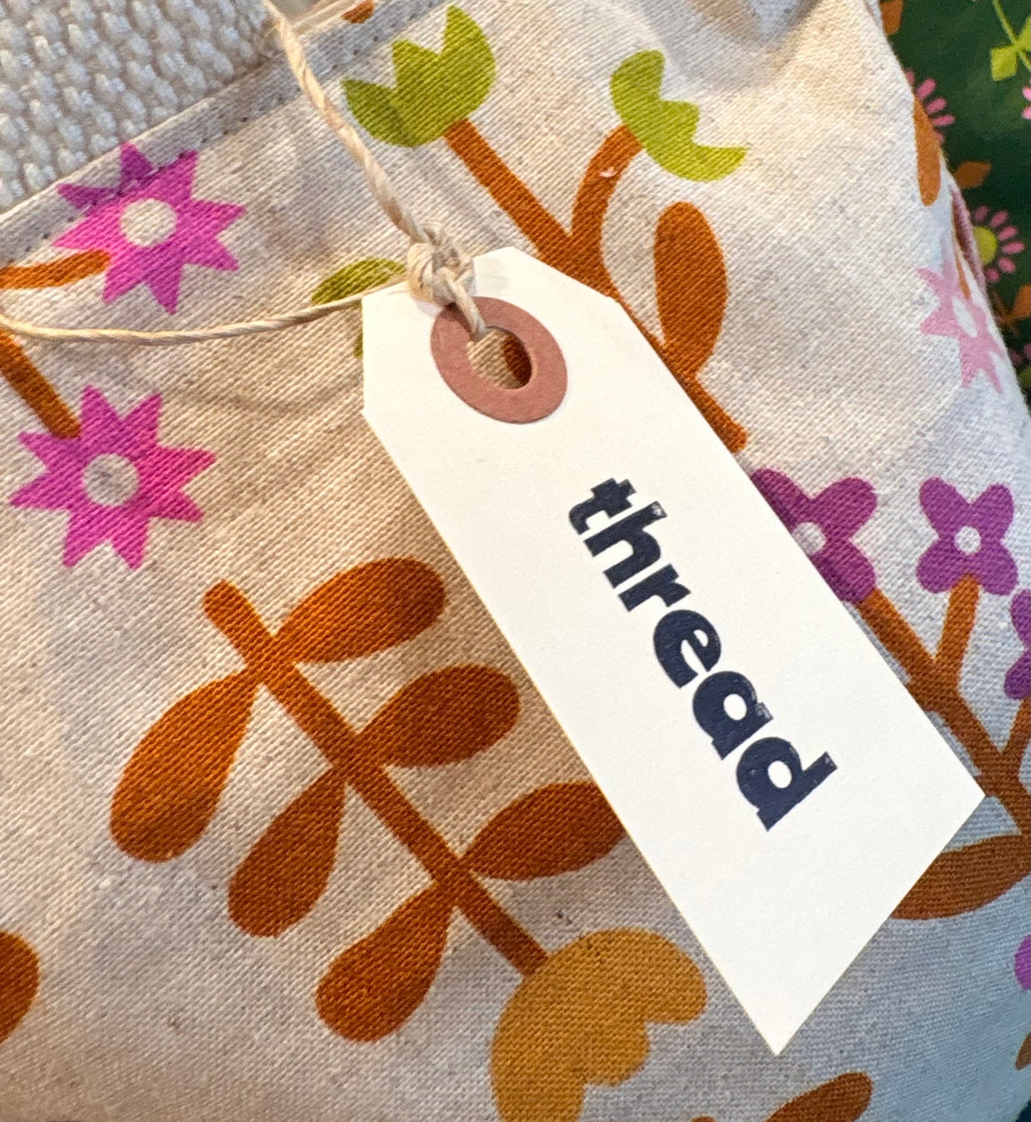 Floral-patterned fabric with a 'thread' tag