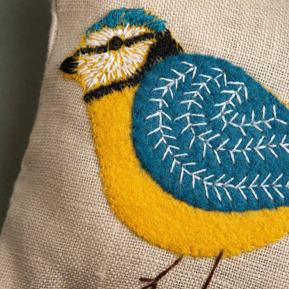 Embroidered bird design on a fabric background