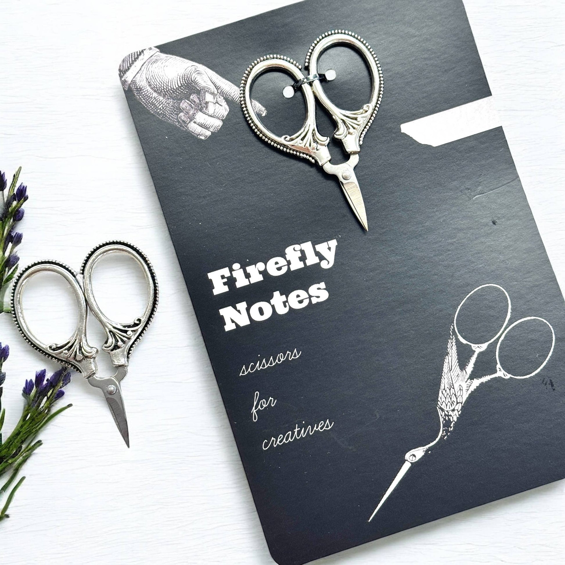 Packaging titled 'Firefly Notes' with decorative scissors on a white background