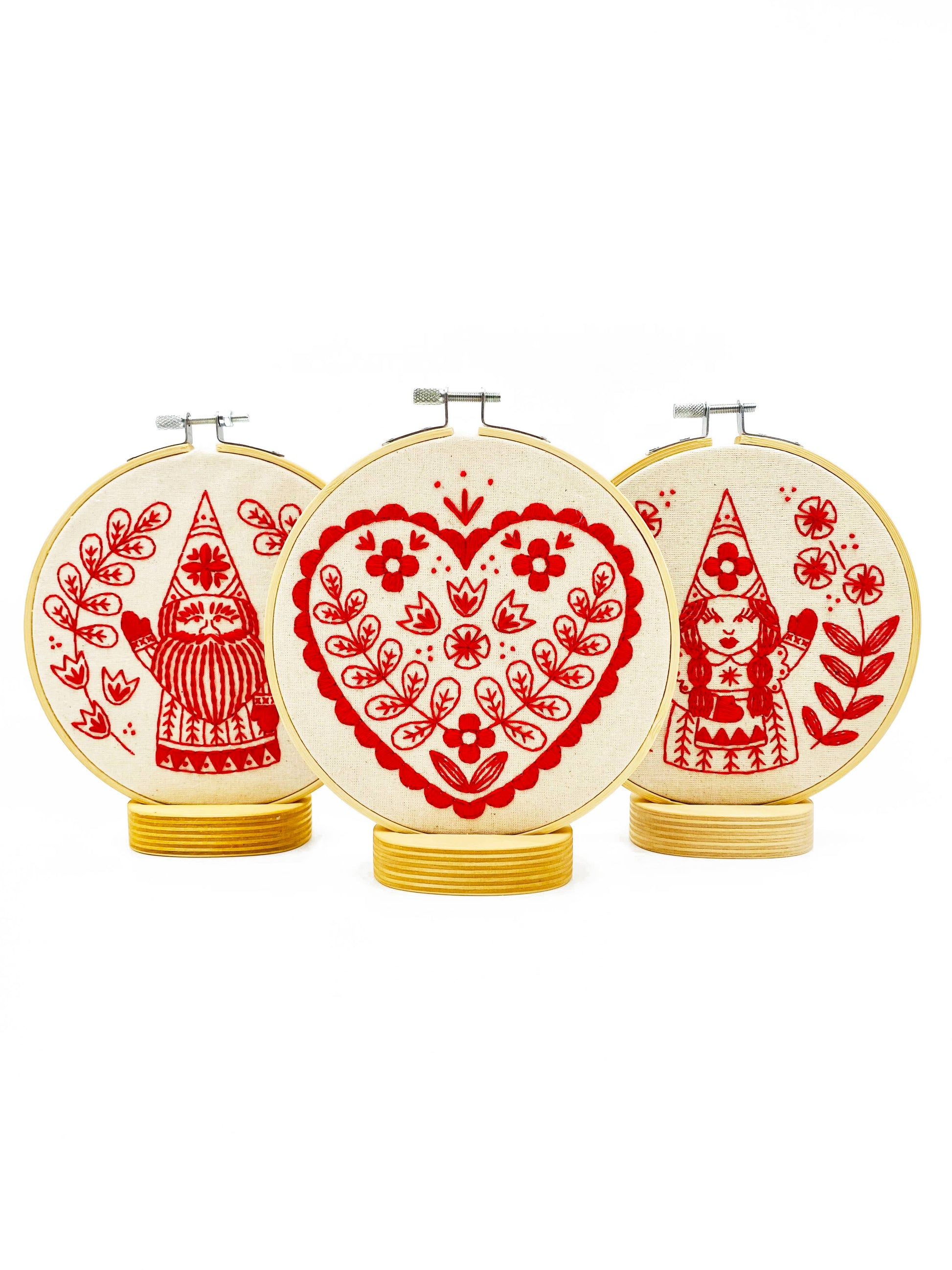 Three decorative hoops with red and white patterns on a white background