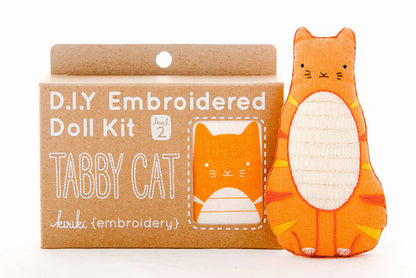 D.I.Y. Embroidered Doll Kit for a tabby cat with an embroidered tabby cat toy next to it on a white background.