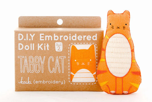 D.I.Y. Embroidered Doll Kit for a tabby cat with an embroidered tabby cat toy next to it on a white background.