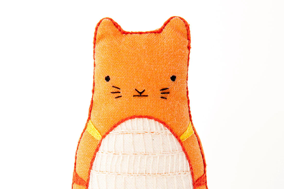 Orange cat-shaped plush toy on a white background