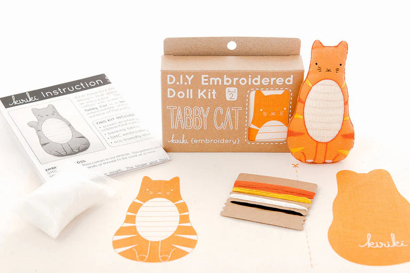 DIY Embroidered Doll Kit with materials and instructions on a white background