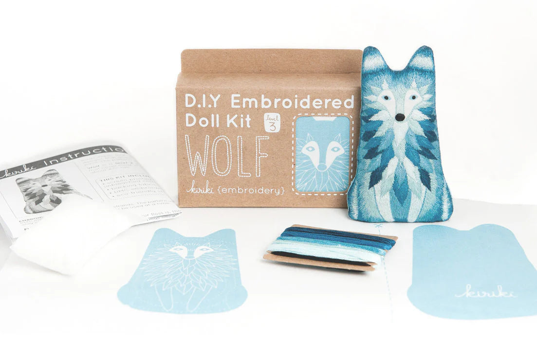 DIY embroidered doll kit with wolf design on a white background