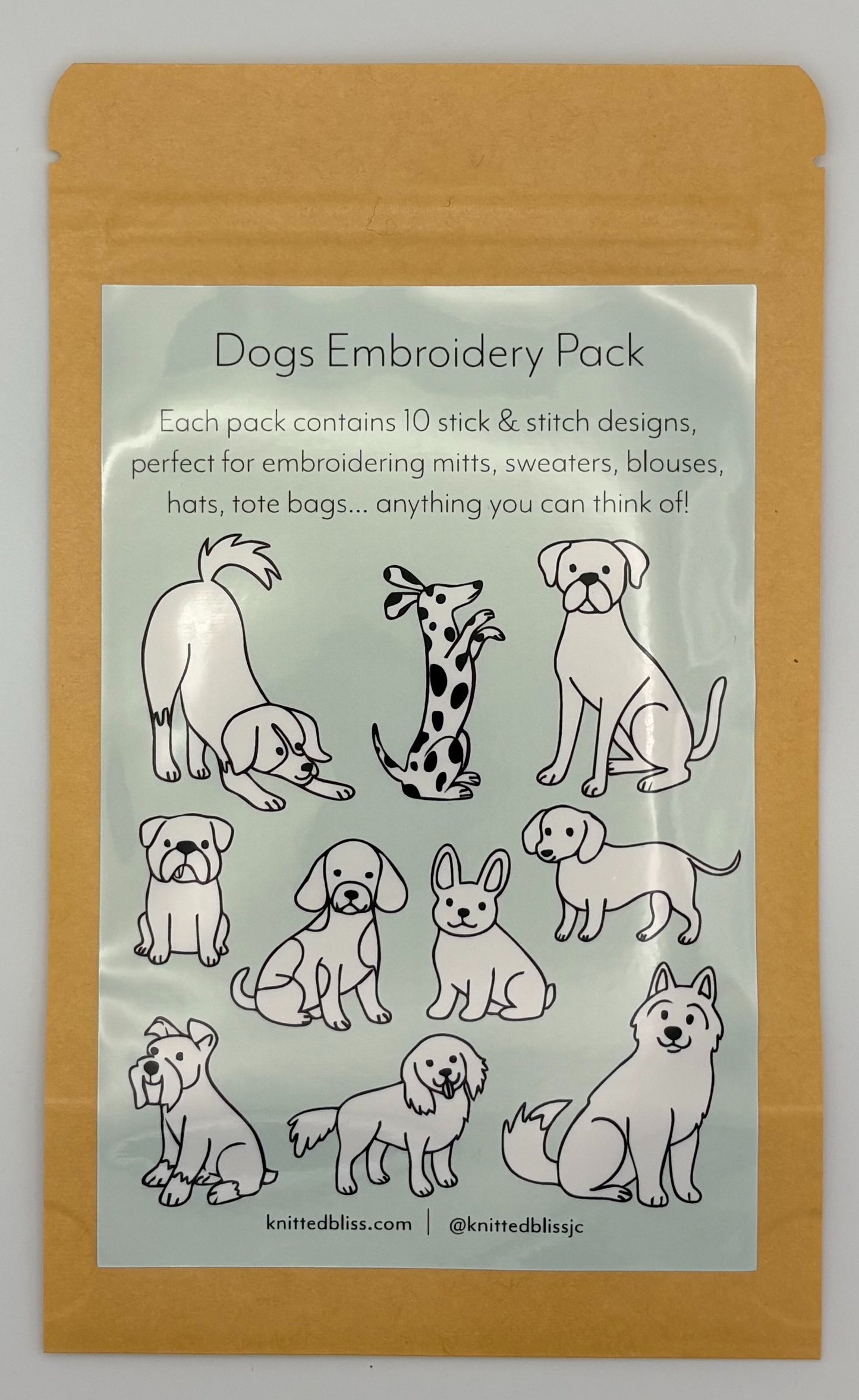 Embroidery pack with dog designs on a clear label inside a brown package.