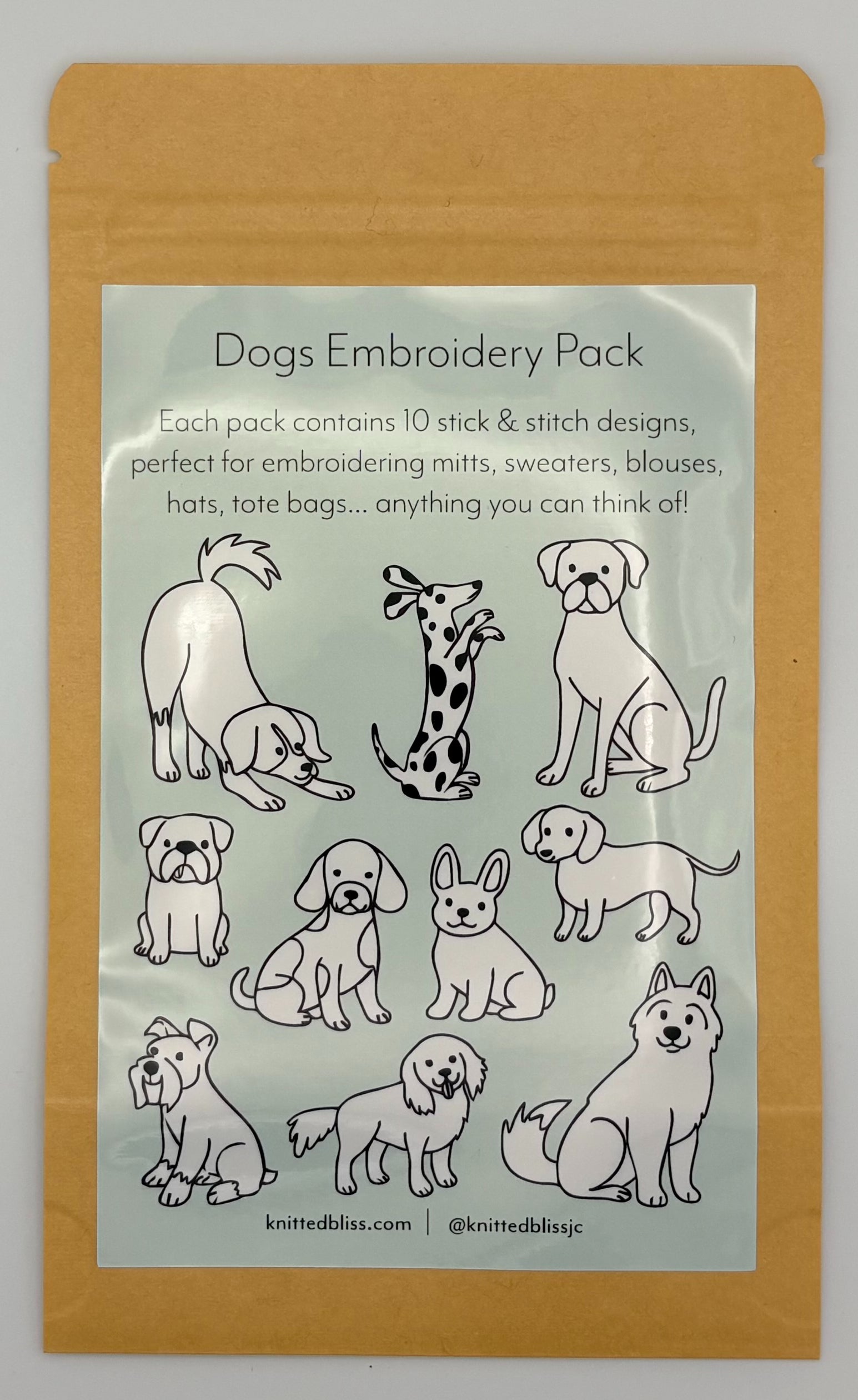 Embroidery pack with dog designs on a clear label inside a brown package.