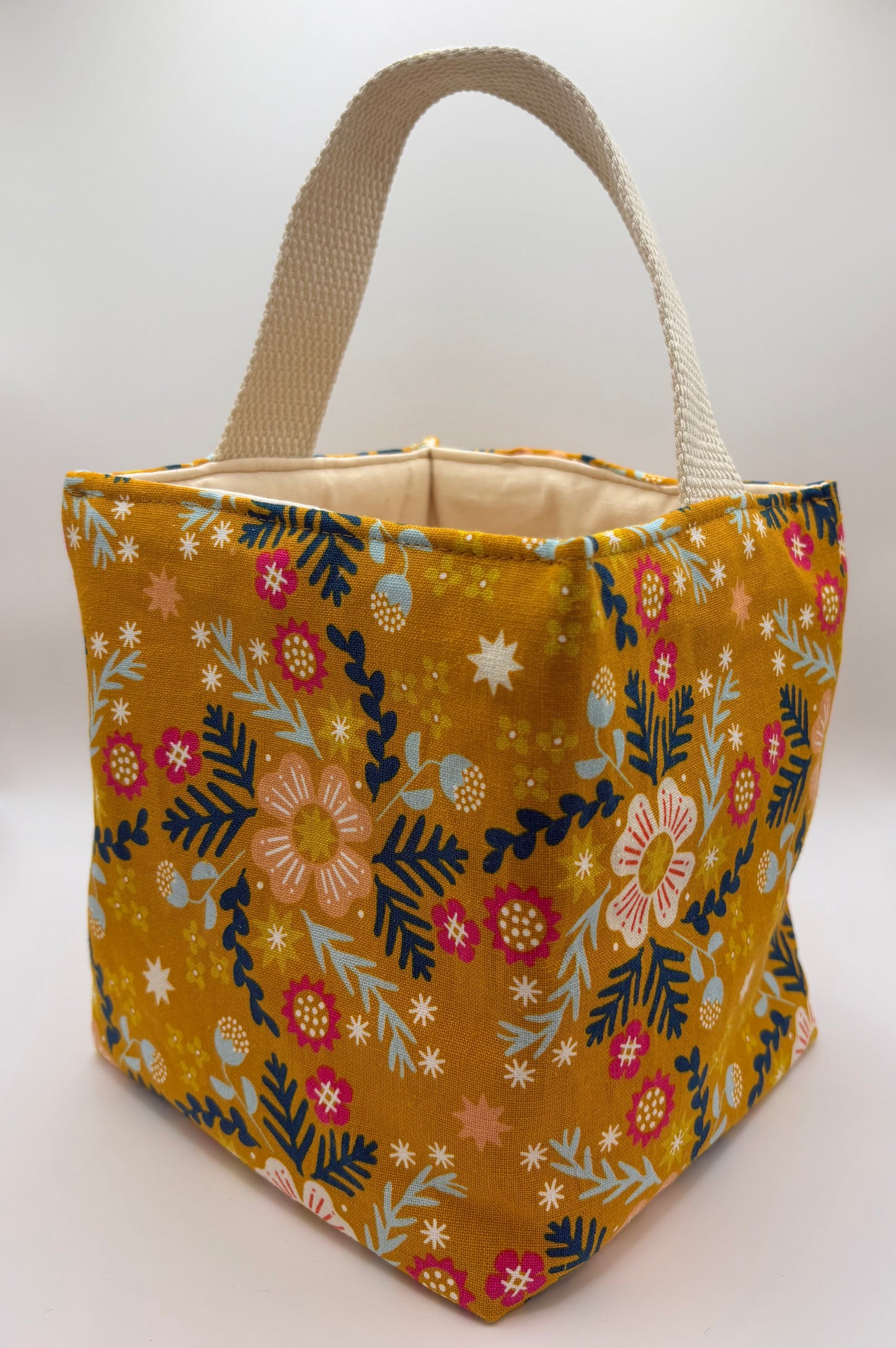 Fabric bag with a yellow floral pattern on a white background